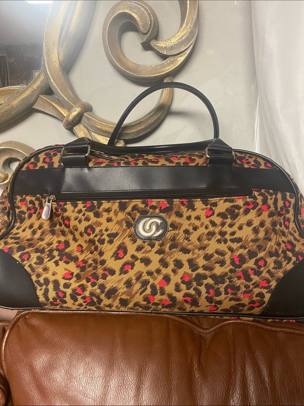 Leopard Print Weekender rolling duffel bag with a brown and red leopard-print